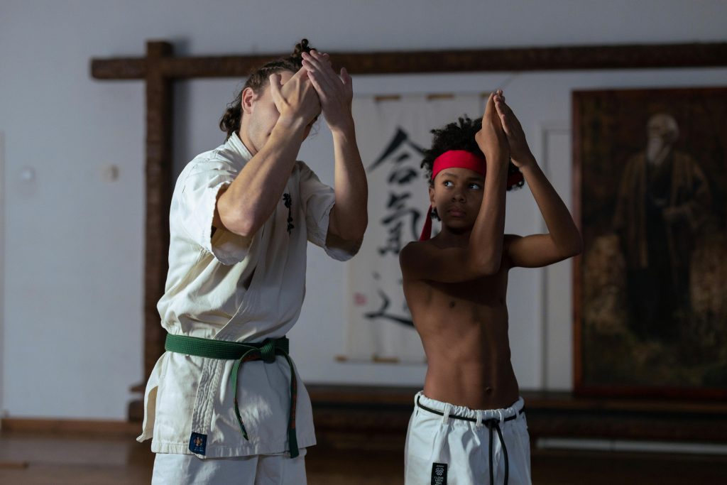 A Boy Training in the Gym with His Trainer